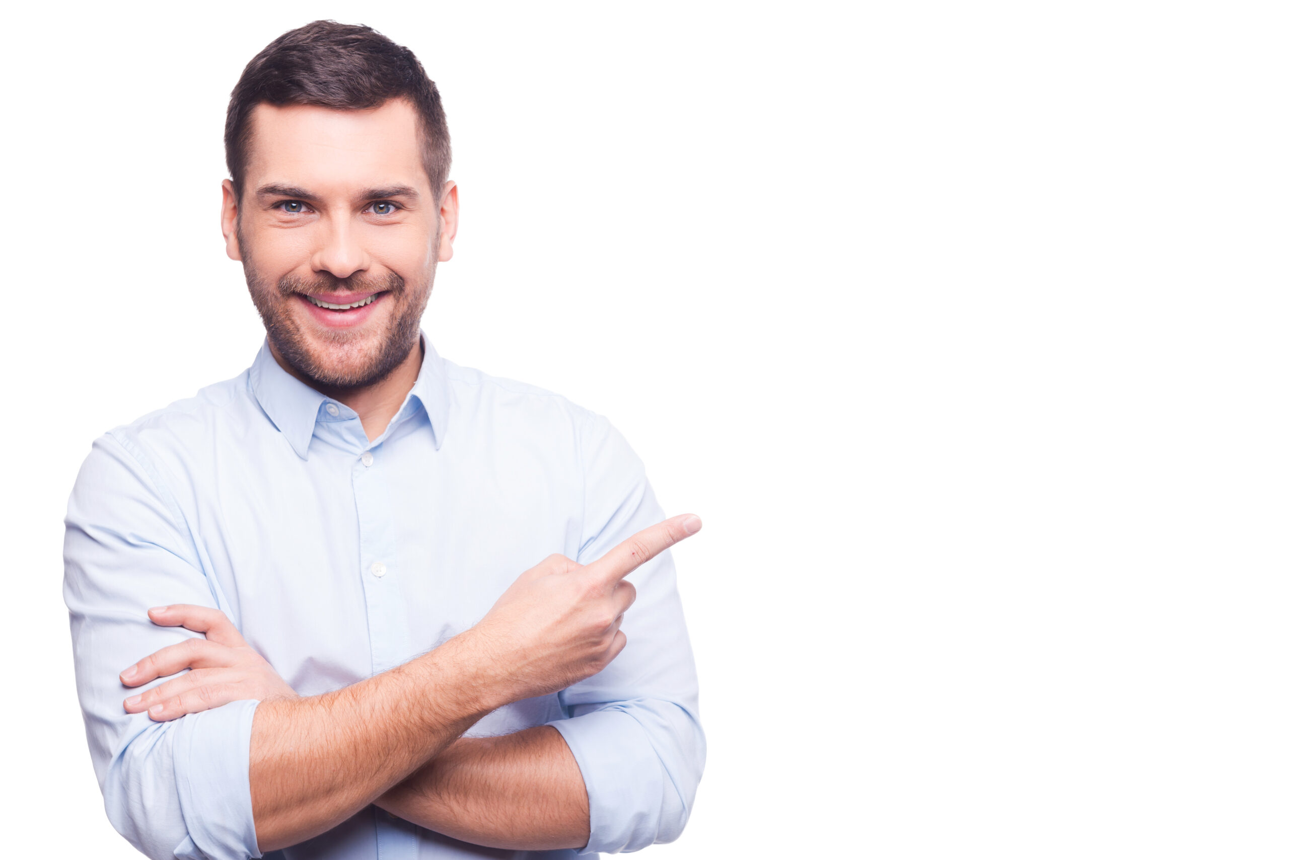Businessman pointing copy space. Handsome young man in shirt looking at camera and pointing away while standing against white background